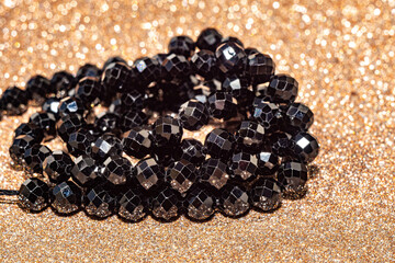 Beautiful faceted beads of black spinel in macro photography, perfect for crafting and jewelry design. Decorative round stone beads of black color for boho jewelry design.