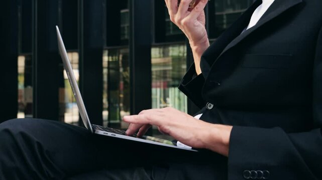 Businessman Uses Laptop, Waiting for a Flight in Airport Terminal or train station, Traveling Entrepreneur Working Online On Computer Sitting in a Boarding Lounge of Airline Hub with Airplanes