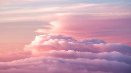 Fototapeta premium A serene view of fluffy clouds bathed in soft pastel hues of pink, purple, and blue, creating a tranquil atmosphere during a sunset.
