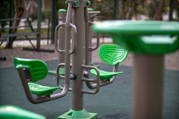 This is a closeup view of a green exercise machine located in a park