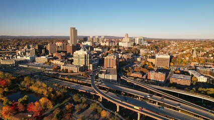 Aerial view of Albany, New York skyline during autumn with vibrant foliage and clear blue sky