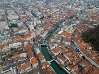 Obraz premium Ljubljana historic city center in the winter. Aerial view above Prešeren Square and Triple Bridge or Tromostovje over Ljubljanica river. Capital city of Slovenia offering many cultural events.