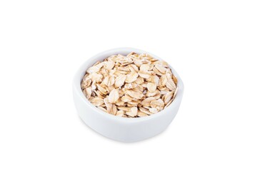 Raw dried oats in a bowl on a white isolated background