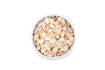 Raw dried oats in a bowl on a white isolated background