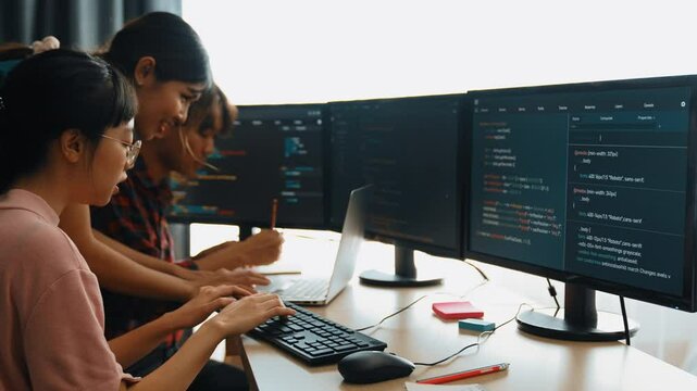 Slow motion back end software developer engineer for computer programming working together on debugging writing computing code, solving complex algorithms display on monitor in office. Burgeoning