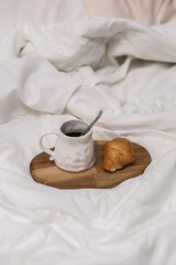 A Cozy and Inviting Breakfast Scene Featuring Fresh Coffee and A Tasty Croissant