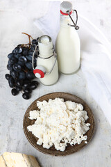 Cottage cheese, milk and cheese on a light background. Natural fresh dairy products.