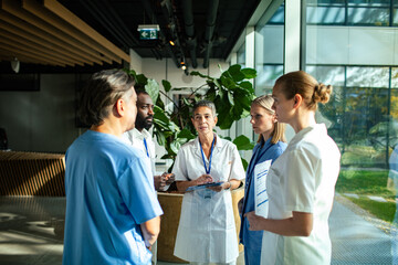 Medical professionals discussing in hospital hallway