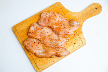 Chicken Boneless preparation for cooking. Raw meat marination 