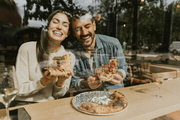 Enjoying delicious pizza together at a cozy café in the afternoon sunlight, sharing laughter and a wonderful meal