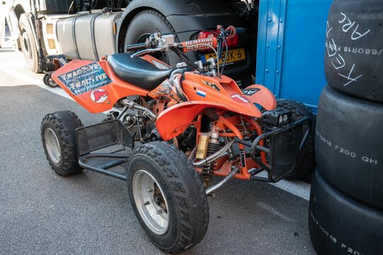 Front view of an orange Chinese quad with worn wheels, it is an FYM 125 Duna