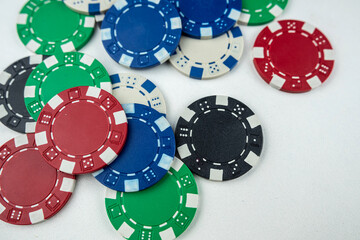 different color poker chips isolated on white gray background