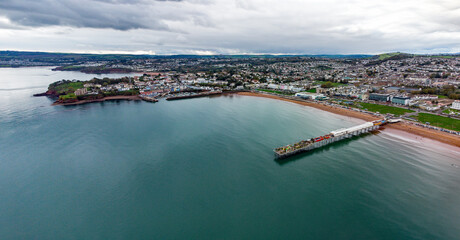 Fototapeta premium Paignton seafront and pier aerial picture looking towards Roundham head. Colourful and vibrant image. Torbay and English Riviera