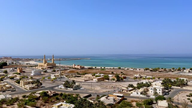 coastal view of Bukha city with traditional architecture and a mosque, Musandam, Oman