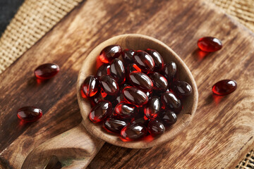 Krill oil gel capsules on a spoon. Nutritional supplement rich in omega-3.