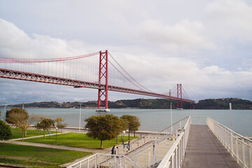 Fototapeta premium Landscape with suspension 25 April bridge bridge over the Tagus river in Lisbon, Portugal.