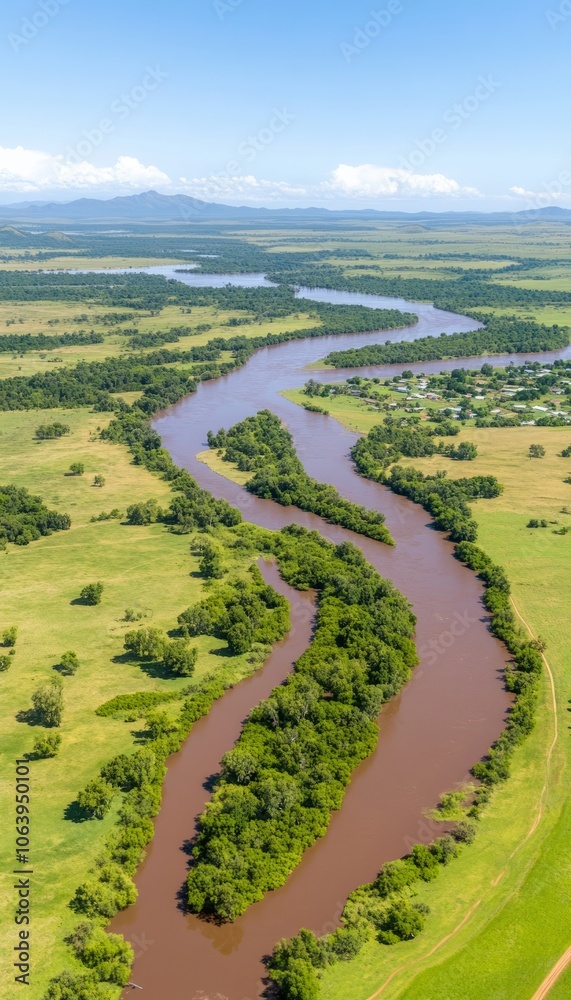 Canvas Prints Aerial view of a winding river flowing through a green grassy landscape.