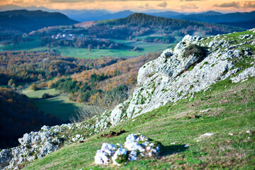 Rocky hillside with panoramic view of rolling hills and autumn forests
