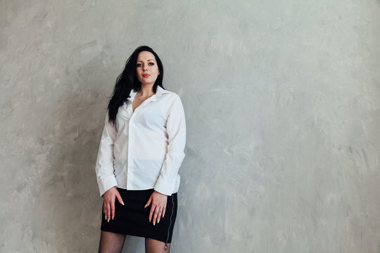 Portrait of a beautiful brunette woman in a white blouse