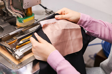 Young woman working with machine in professional workshop, closeup