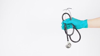 Hands is  hold Stethoscope and wear mint green latex gloves on white background..