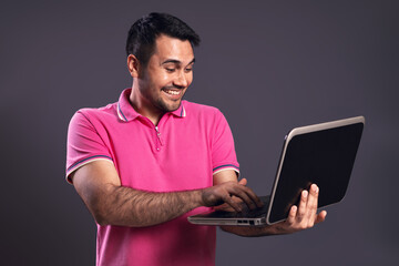 Portrait of Brazilian man wearing polo shirt in pink