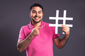 Portrait of Brazilian man wearing polo shirt in pink