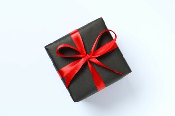 Beautiful gift box tied with bow on white background 
