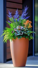 Decorative garden planter with colorful flowers and lush greenery, arranged in a sleek terracotta-colored pot. A stylish addition for outdoor spaces, combining natural beauty with modern design.


