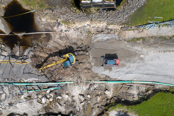Destroyed bridge after hurricane flooding in Florida. Construction equipment at roadwork site....