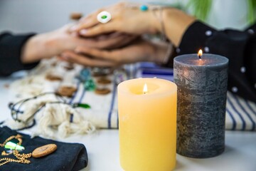 A fortune teller reads with tarot cards. Selective focus.