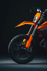 Cropped image of sport motorcycle on dark background. Minimalistic shot of modern sport bike