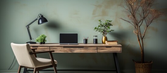 A modern workspace featuring a wooden desk, laptop, lamp, and decorative plants.
