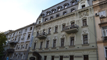 Classic European building facade with decorative balconies and detailed architecture, evoking elegance and historic charm in an urban neighborhood.