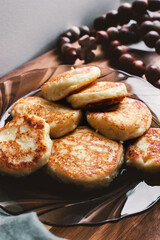 Vanilla cottage cheese pancakes ( syrniki or curd fritters) on in winter morning. High-protein breakfast ideas. Vertical image.
