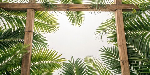 Fototapeta premium Palm leaves in shades of emerald and olive are arranged in a circular pattern on a wooden frame like a work of art, leafy greens, palm leaves