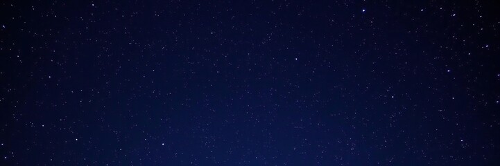 Obraz premium Starry night sky with multiple stars and galaxies in a dark blue background, nebula, cosmic phenomena, galaxy cluster