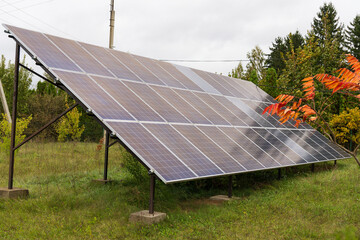 A row of solar panels stands proudly in a peaceful meadow, soaking up sunlight amidst lush greenery, showcasing eco-friendly technology in harmony with nature