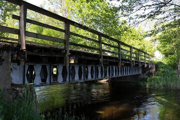 Old steel and wooden bridge over the river in Borki in Masuria, Poland