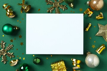 Festive Christmas background with paper card and different decorations, balls and confetti 