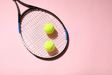 Tennis racket and balls on color background