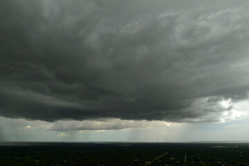 Rain shower water pouring down from stormy clouds during summer thunderstorm in Florida