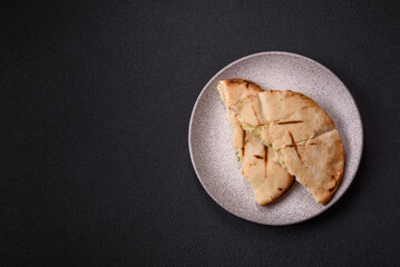 Round flatbread or pita with cheese, herbs, salt and spices
