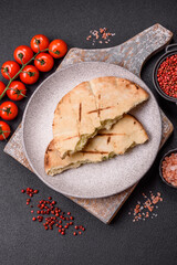Round flatbread or pita with cheese, herbs, salt and spices