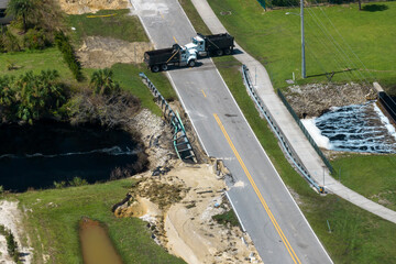 Roadblock at damaged road bridge destroyed by river after flood water washed away asphalt....