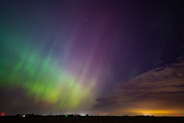 Northern Lights Storm on May 11th 2024 from Iowa City, Iowa, USA with a cloud being illuminated by a light below. 5.11.24