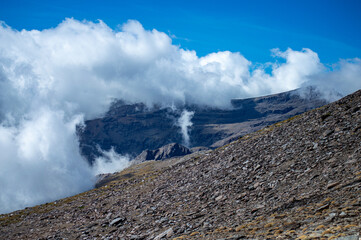 Cloudy over mountains on hiking trail to Mulhacen peak, Sierra Nevada National park, Andalusia, Spain