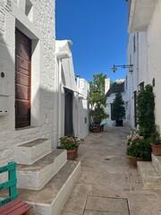 Naklejka premium Charming Narrow Alley with Whitewashed Buildings in Ostuni, Italy
