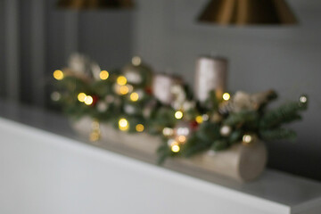 Blurred Christmas floral composition of fresh Nobilis. Cotton flowers spruce, sparkling ornaments. Holiday concept. Happy New Year decorations. Ideal decoration article for office and home tables.