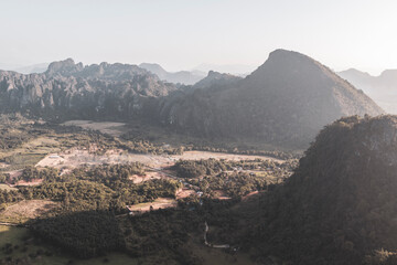 Mountain landscape with tropical jungle fields in Vang Vieng Laos.